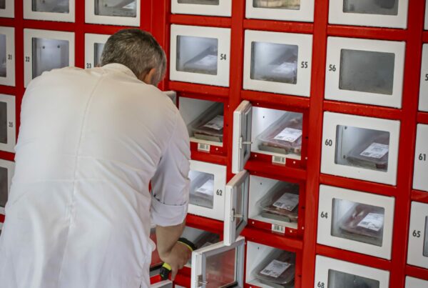 A butcher using the barecode kit to fill the locker